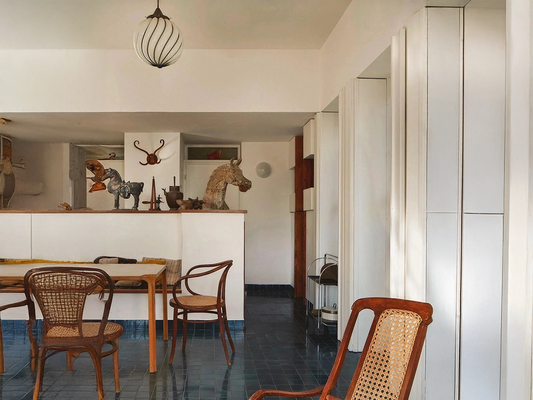 A Dining Room Framed by Art and Curves