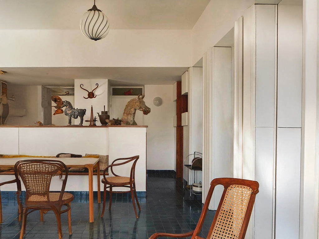 A Dining Room Framed by Art and Curves