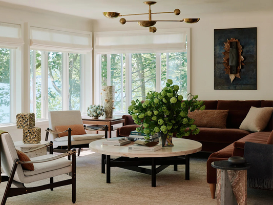 Modern Layers: Brown Sofas and Sculptural Brass Lighting